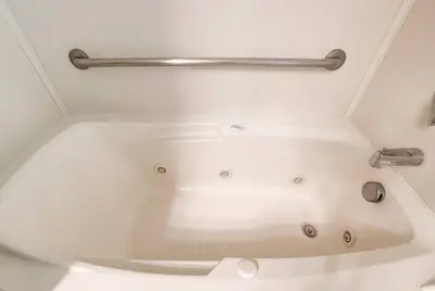 a white bath tub in a bathroom with a metal rail at Tahoe Snowbird Retreat in Stateline