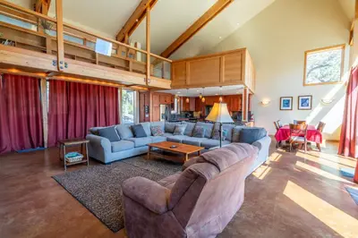a living room with a couch and a table at Rr-carson_view1 Strap18-005 in June Lake