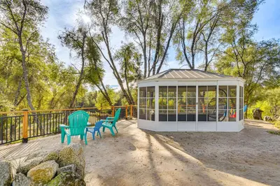 two chairs and a gazebo on a patio at Private Lake, Hot Tub and EV Charger Mariposa Home! in Mariposa