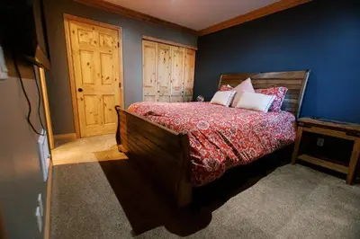 a bedroom with a bed and a wooden door at BEST Location . Walk To Canyon Lodge . Views . Pool/Spa in Mammoth Lakes