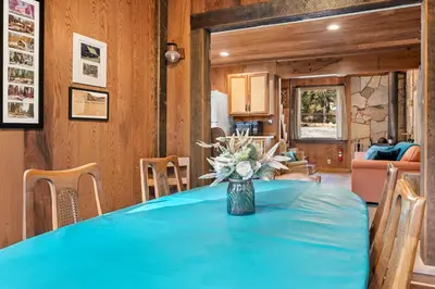 a blue table with a vase of flowers on it at The Knotty Cabin in Kings Canyon National Park in Wilsonia