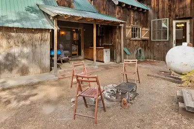 two wooden chairs sitting outside of a building at The Knotty Cabin in Kings Canyon National Park in Wilsonia
