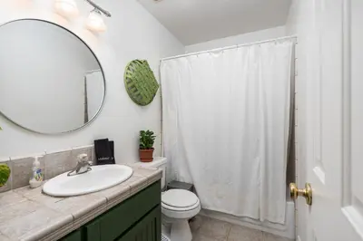a bathroom with a sink and a toilet and a mirror at Lupine Landing in Mariposa