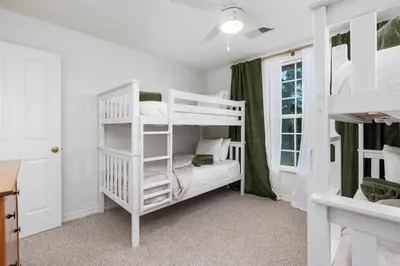 a bedroom with two bunk beds and a window at Lupine Landing in Mariposa