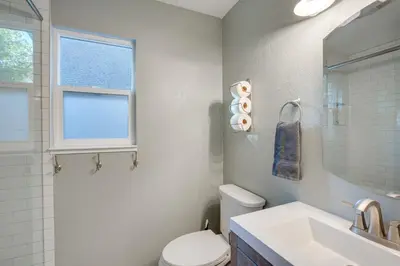 a bathroom with a toilet and a sink and a window at Ski and Board in South Lake Tahoe! Updated Home in South Lake Tahoe