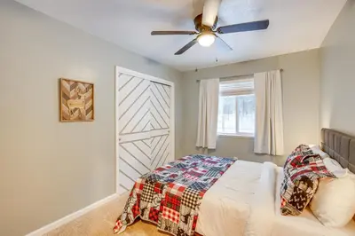 a bedroom with a bed and a ceiling fan at Ski and Board in South Lake Tahoe! Updated Home in South Lake Tahoe