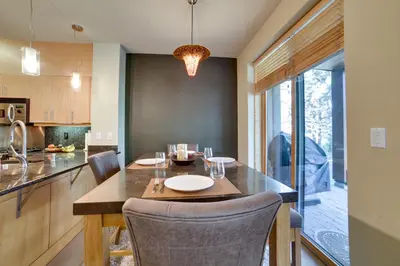 a kitchen with a table with chairs and a dining room at Mammoth Lakes Condo with Fireplace Near Skiing! in Mammoth Lakes