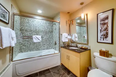 a bathroom with a tub and a toilet and a sink at Mammoth Lakes Condo with Fireplace Near Skiing! in Mammoth Lakes