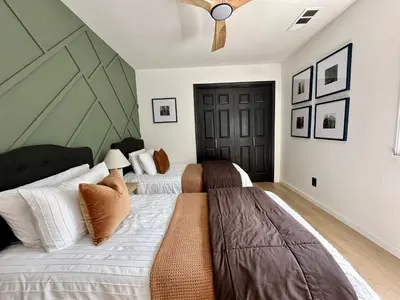 a bedroom with two beds and a ceiling fan at Prime location Yosemite Adventure by Casa Oso in Oakhurst