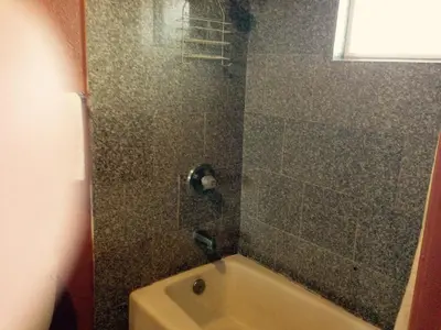 a bathroom with a shower with a bath tub at Valley Motel in Atwater
