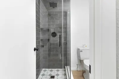 a shower with a glass door in a bathroom at The Charlotte Sequoia Motel R2 in Three Rivers