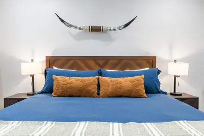 a bedroom with a blue bed with two lamps at The Moro | Sequoia Motel RM3 in Three Rivers