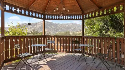 a gazebo with two tables and chairs on a deck at The Moro | Sequoia Motel RM3 in Three Rivers