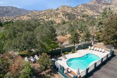 an overhead view of a swimming pool with mountains in the background at The Moro | Sequoia Motel RM3 in Three Rivers