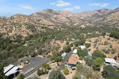 an aerial view of a town with mountains in the background at The Belle Sequoia Motel RM9 in Three Rivers