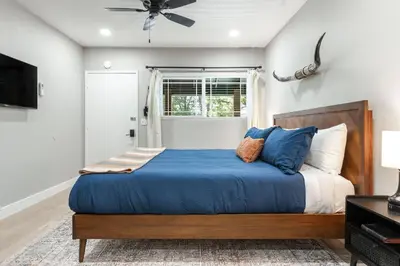 a bedroom with a bed with blue sheets and a ceiling fan at The Tokopah Sequoia Motel RM 1 in Three Rivers