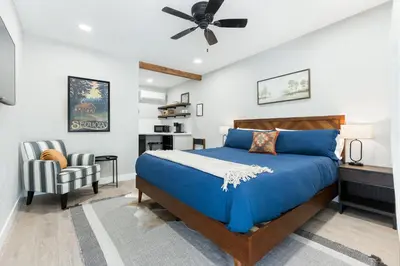 a bedroom with a blue bed and a chair at The Heather Sequoia Motel RM 4 in Three Rivers
