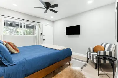 a bedroom with a bed and a tv and a chair at The Heather Sequoia Motel RM 4 in Three Rivers