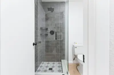 a bathroom with a shower with a glass door at The Heather Sequoia Motel RM 4 in Three Rivers