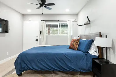 a bedroom with a blue bed and a ceiling fan at The Rae | Sequoia Motel RM 5 in Three Rivers
