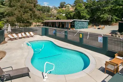 a small swimming pool with chairs and a fence at The Atwell Sequoia Motel RM 8 in Three Rivers