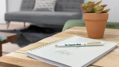 a pen sitting on top of a notebook on a table at The Whitney- Sequoia Motel RM7 in Three Rivers