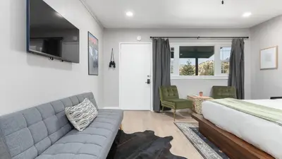a bedroom with a couch and a bed and a window at The Whitney- Sequoia Motel RM7 in Three Rivers