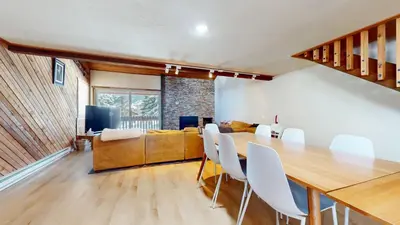 a dining room and living room with a table and chairs at Snowcreek I #52 condo in Mammoth Lakes