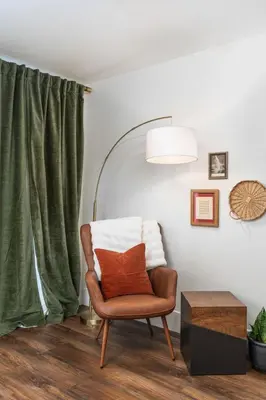a chair with a pillow in a room with a window at Manzanita Rest in Mariposa