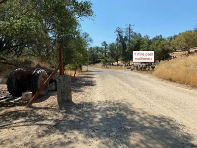 a sign on the side of a dirt road at Peaceful & secluded, yet close to town. in Mariposa