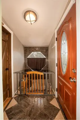 a hallway with a wooden door and a ceiling at Cedar Ridge Hot Tub BBQ Sleeps 8 in Oakhurst