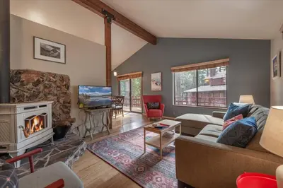 a living room with a couch and a fireplace at Cozy Pet-Friendly Cabin w Fenced-In Yard Close to Slopes Beach Town in Carnelian Bay