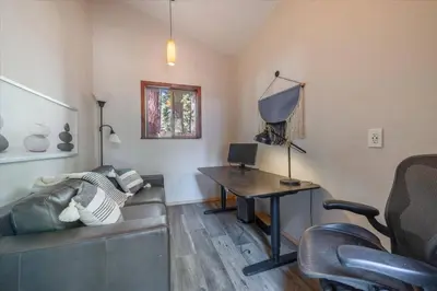 a living room with a couch and a table at Cozy Pet-Friendly Cabin w Fenced-In Yard Close to Slopes Beach Town in Carnelian Bay