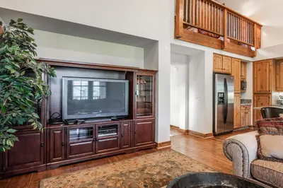 a living room with a large entertainment center with a television at Lodges 1112 - 3 Bed townhome with Loft in Mammoth Lakes