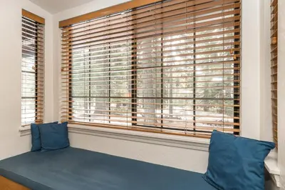 a window with a blue couch in front of it at Donner Lake Inn in Truckee