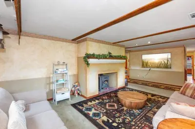 a living room with a couch and a fireplace at SEQUOIA LOOKOUT LODGE in Three Rivers