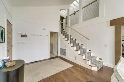 a living room with a staircase in a house at Steps to Beach Family Home with Views in Tahoe City in Tahoe City