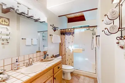 a bathroom with a toilet sink and a shower at Wishing Well Cabin in Bass Lake
