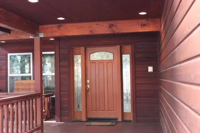 a front door of a home with a wooden wall at Big Luxury South Lake Tahoe Home in South Lake Tahoe
