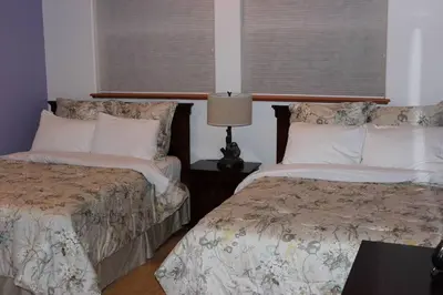a bedroom with two beds and a lamp on a table at Big Luxury South Lake Tahoe Home in South Lake Tahoe