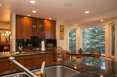 a kitchen with a sink and a table with chairs at Big Luxury South Lake Tahoe Home in South Lake Tahoe