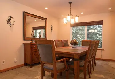 a dining room with a table and chairs and a mirror at Big Luxury South Lake Tahoe Home in South Lake Tahoe