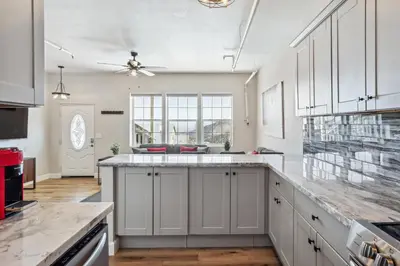 a kitchen with white cabinets and a large counter top at Mtn-View Apt with Deck in Historic Virginia City in Virginia City