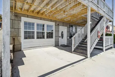 a house with a white garage door and stairs at Mtn-View Apt with Deck in Historic Virginia City in Virginia City