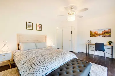 a bedroom with a bed and a ceiling fan at Waterfront Mariposa Vacation Rental with Hot Tub in Mariposa