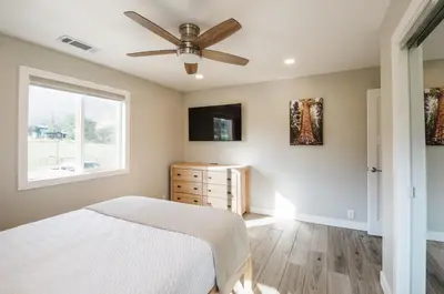 a bedroom with a bed and a ceiling fan at Dennison House in Three Rivers