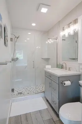 a bathroom with a shower and a toilet and a sink at Dennison House in Three Rivers