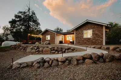 a rock garden in front of a house at Dennison House in Three Rivers