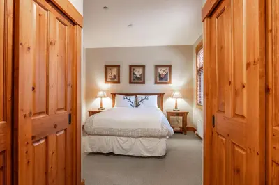 a bedroom with a bed and two lamps in a room at Cabins 1 in Mammoth Lakes