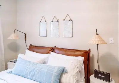 a bedroom with a bed with two lamps and mirrors at Oasis East Sac Charming Home with Saltwater Pool and Casita in Sacramento